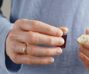 young-christian-woman-holds-bread-and-wine-the-elements-for-communion-SBI-351578727 young-christian-woman-holds-bread-and-wine-the-elements-for-communion-SBI-351578727
